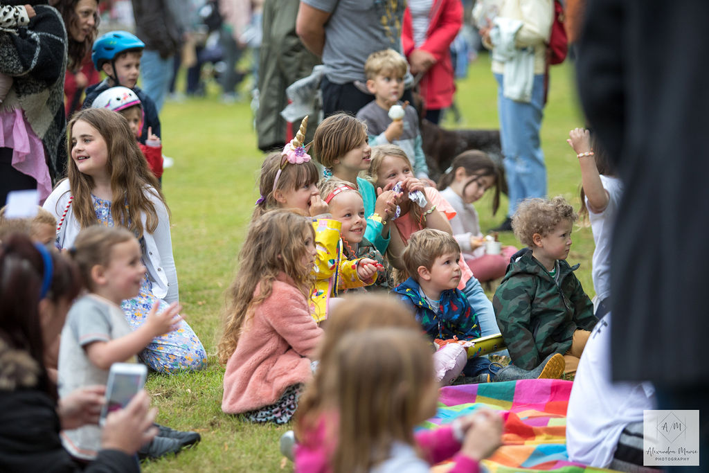 Children and parents enjoying Punch and Judy